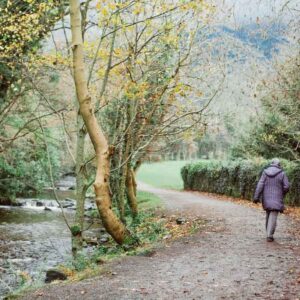 woman on path next to stream