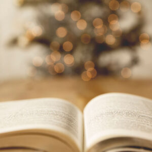 Bible open in front of a Christmas tree