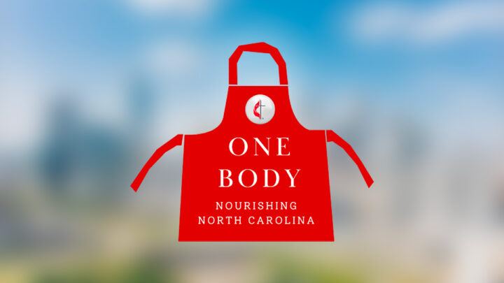 One Body: Nourishing North Carolina | red apron with cross & flame button over a blurred Charlotte skyline