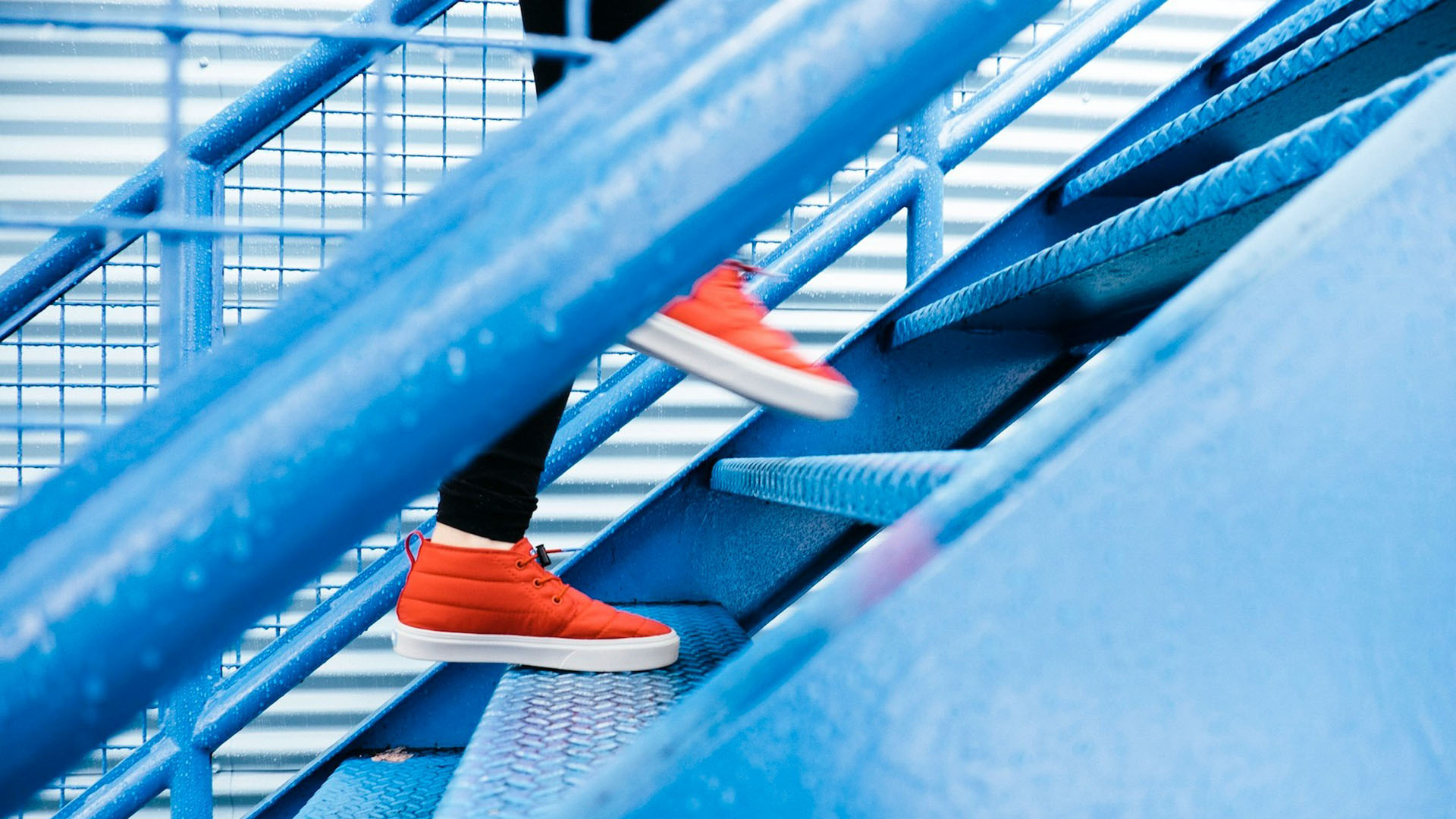 Person running up blue stairs