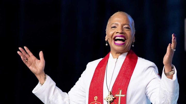 Bishop Tracy S. Malone holding up her hands while preaching