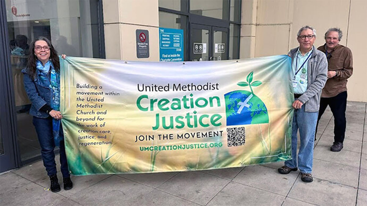 From left: Denise Honeycut), Pat Watkins and Dan Joranko of the UM Creation Justice Movement greet attendees of the 2024 General Conference in Charlotte, N.C. File photo courtesy of UM Creation Justice Movement.